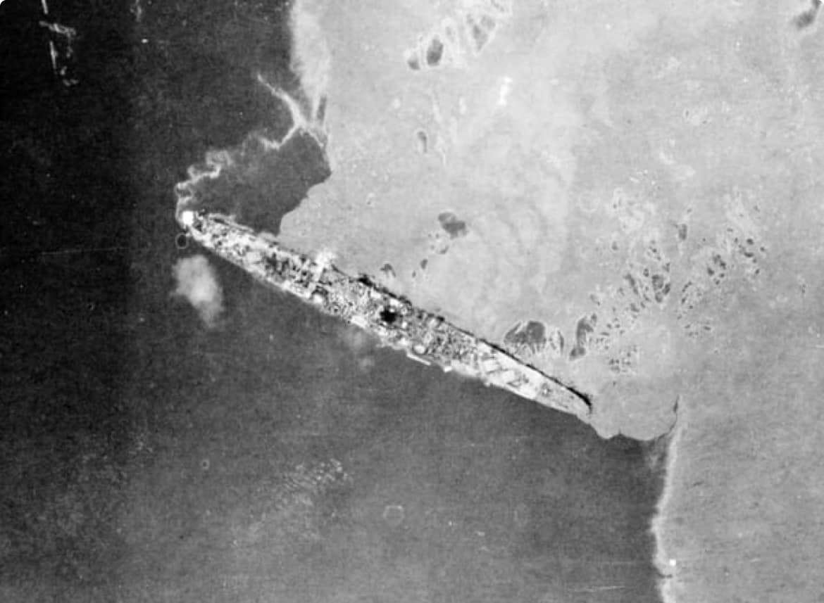 yahagi-light-cruiser-sunk-operation-ten-go-photograph The light cruiser Yahagi lying dead in the water (NH 62588) after multiple torpedo hits, illustrating the systematic destruction of the Yamato's escort screen